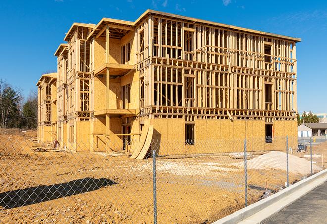 a close-up of temporary chain link fences enclosing a construction site, signaling progress in the project's development in Bannockburn IL